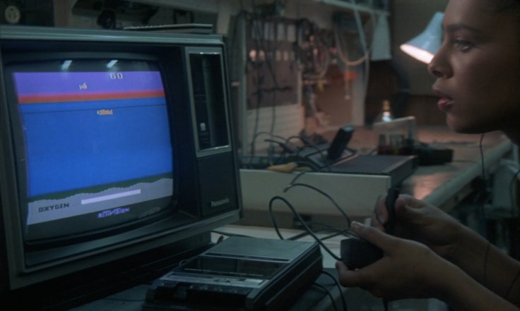 Iris Peynado playing the Atari game "Shark Hunter" in "Devil Fish" (1984)