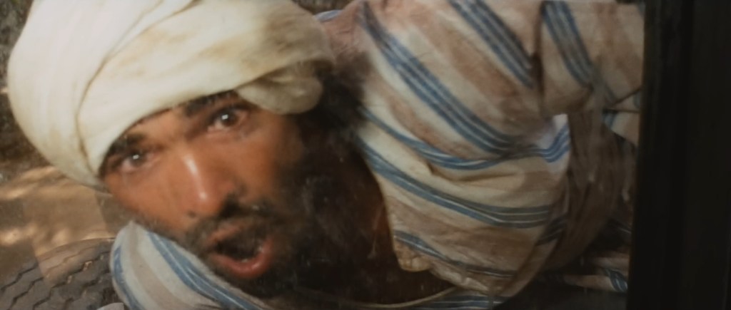 Reaction shot from "Raiders of the Lost Ark" (1981) where Indy crashes a truck into a bunch of manual laborers, and this guy is just like "wow!"